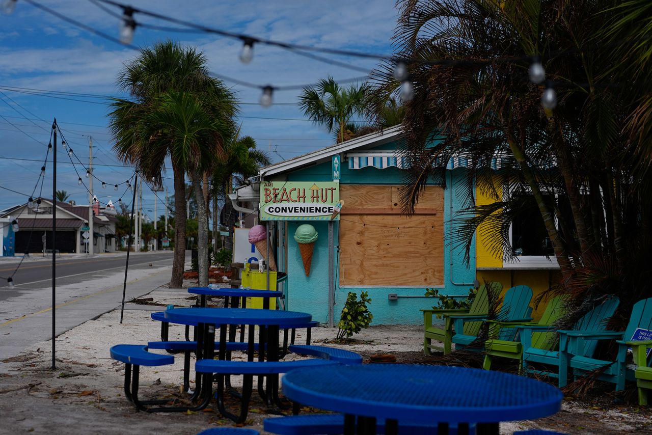 A boarded up business stands beside a deserted street in an evacuation zone on Florida's Anna Maria Island on October 8, 2024.