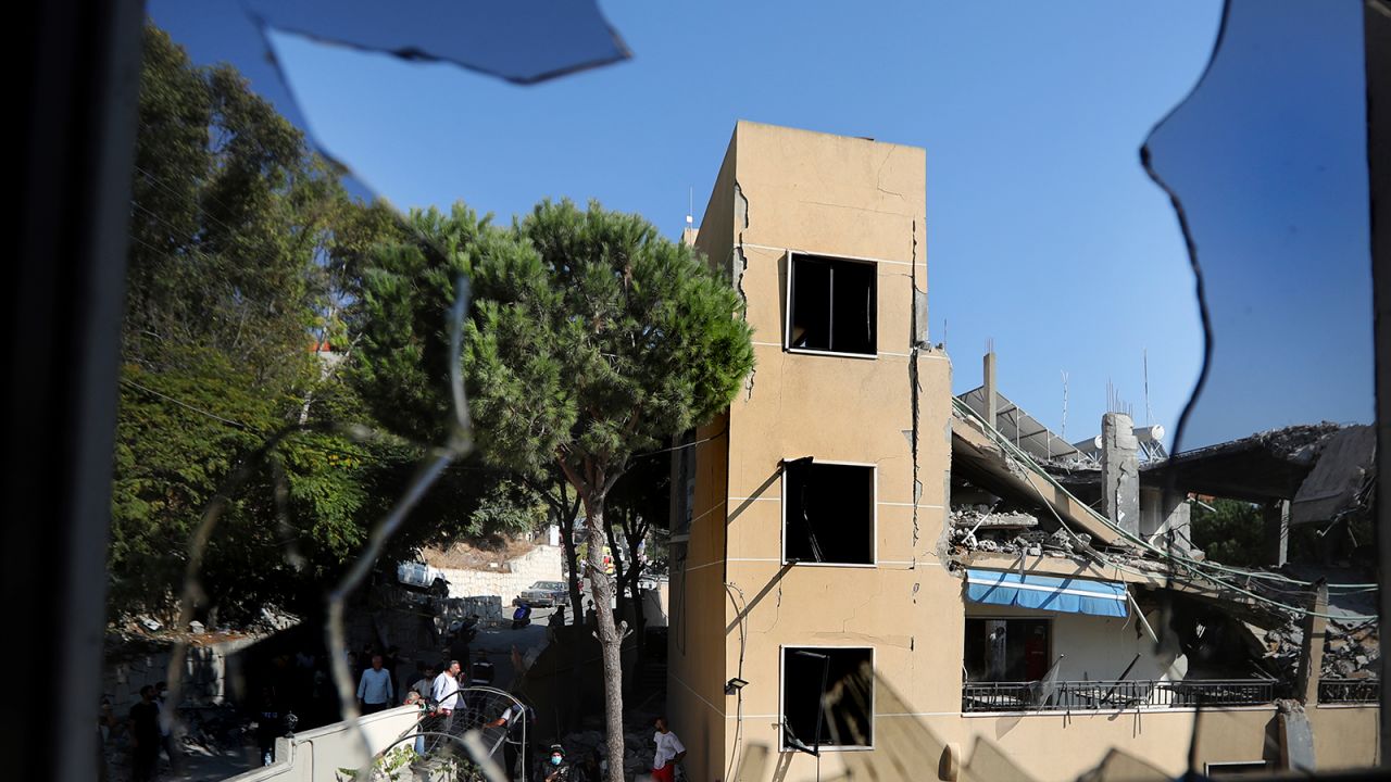 A destroyed hotel-turned-shelter for displaced people hit by an Israeli airstrike is seen through a broken window, in Wardaniyeh, south Lebanon, on October 9.