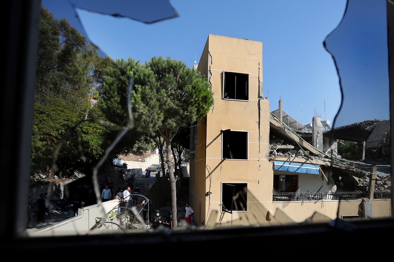 A destroyed hotel-turned-shelter for displaced people hit by an Israeli airstrike is seen through a broken window, in Wardaniyeh, south Lebanon, on October 9.