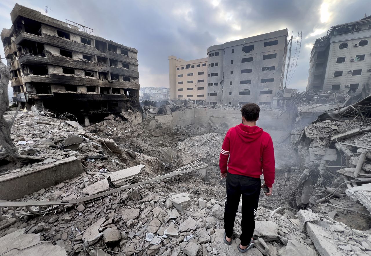 A man looks at destroyed buildings hit by Israeli airstrikes in the southern suburbs of Beirut, Lebanon, on October 7.