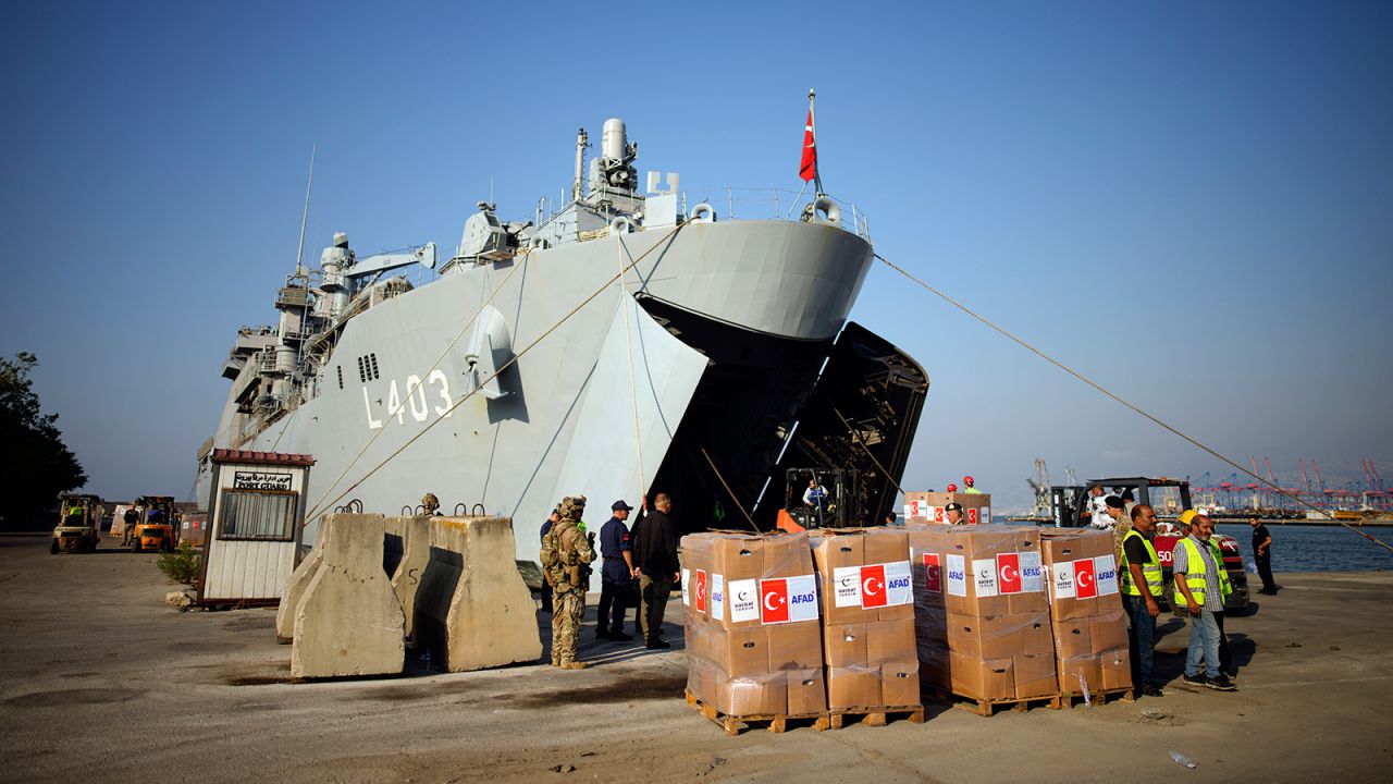 Workers unload humanitarian aid from a Turkish military ships, in the port of Beirut, Lebanon, on October 9.