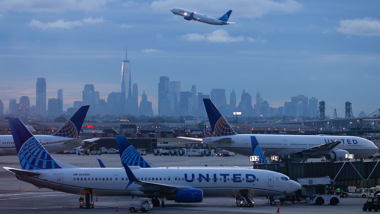 The lower Manhattan skyline, One World Trade Center and the city are seen in the background in front of United Airlines jets during sunrise at Newark Liberty International Airport (EWR), Friday, Sept. 20, 2024, in Newark, N.J. (Aaron M. Sprecher via AP)