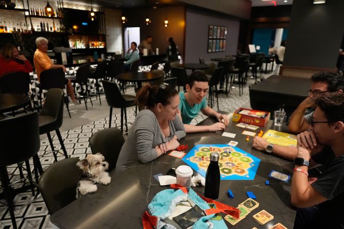 The Segundo family, who evacuated from nearby Davis Island, plays a board game at a hotel in Tampa on Wednesday.