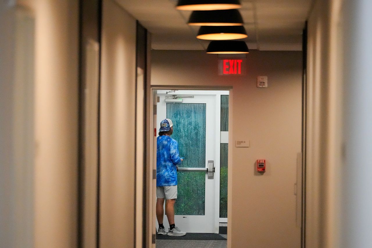 Davis Jones looks out the door of the hotel where he is riding out Hurricane Milton, in Tampa, Florida on October 9.