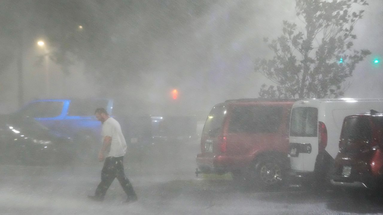 Max Watts walks in the parking lot to check on a trailer parked outside the hotel where he was riding out Hurricane Milton with coworkers, on Wednesday, October 9, in Tampa, Florida.