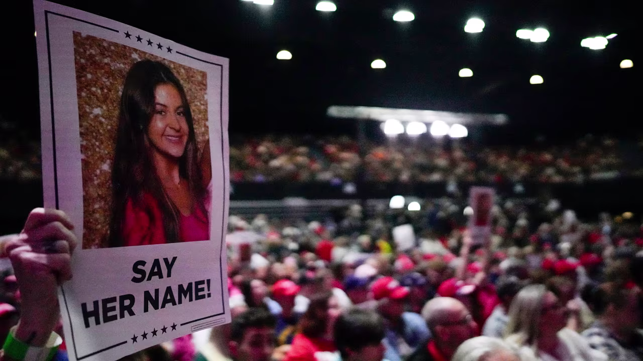 A supporter holds a sign with a photo of Laken Riley before Republican presidential candidate former President Donald Trump speaks at a campaign rally on March 9 in Rome, Georgia.