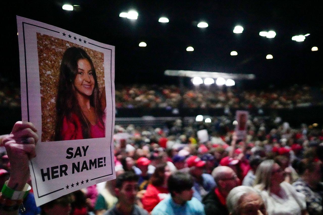 A supporter holds a sign with a photo of Laken Riley before Republican presidential candidate former President Donald Trump speaks at a campaign rally on March 9 in Rome, Georgia.