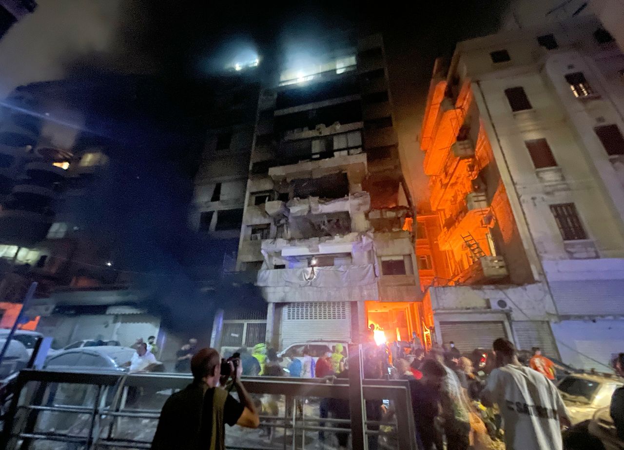 People gathered in front a destroyed building hit by an Israeli airstrike in central Beirut, on Thursday.