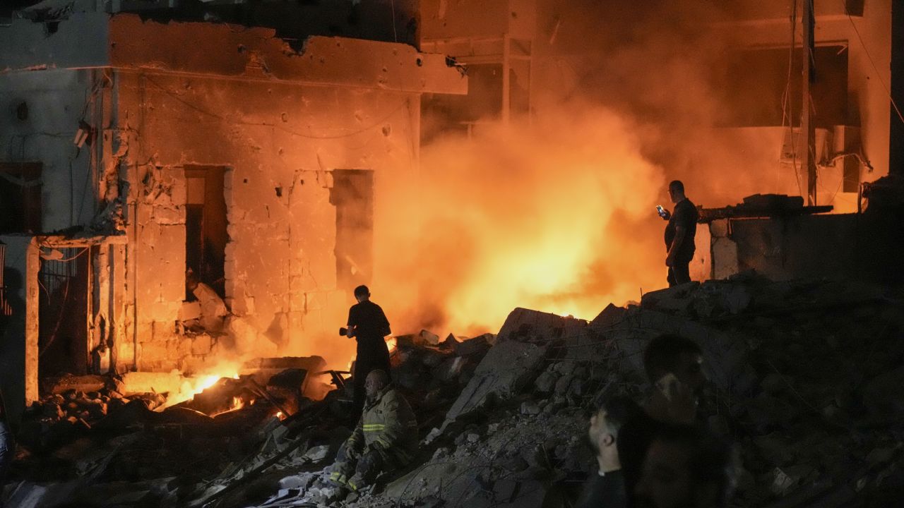 Flames and smoke rise at the scene of destroyed buildings hit by an Israeli airstrike in central Beirut, Lebanon, on Thursday, October 10.