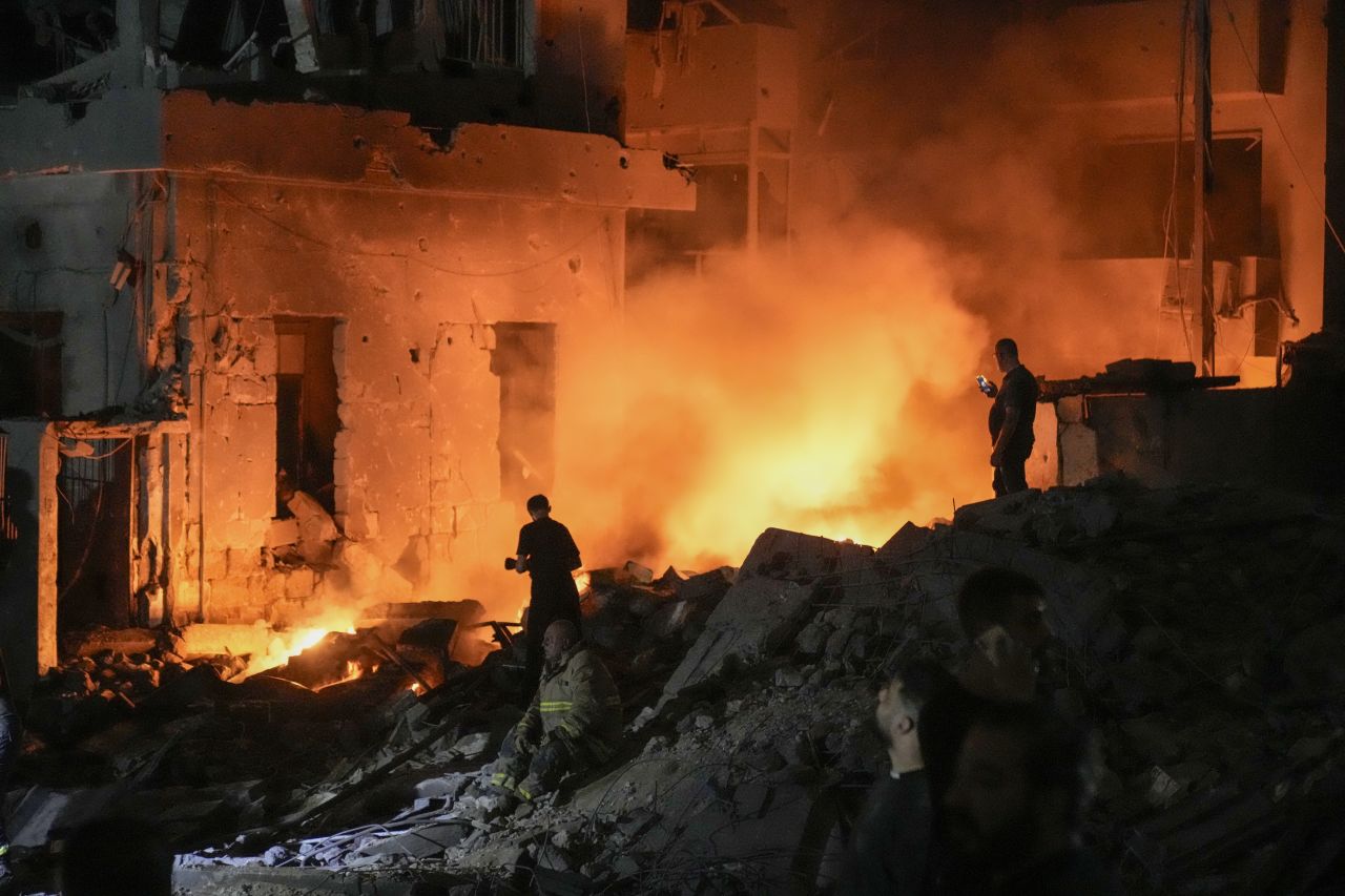 Flames and smoke rise at the scene of destroyed buildings hit by an Israeli airstrike in central Beirut, Lebanon, on Thursday, October 10.