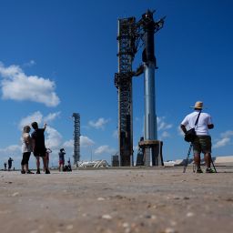 Onlookers watch as SpaceX's Starship rocket is prepared for a test launch in Boca Chica, Texas, Saturday, Oct. 12, 2024. (AP Photo/Eric Gay)