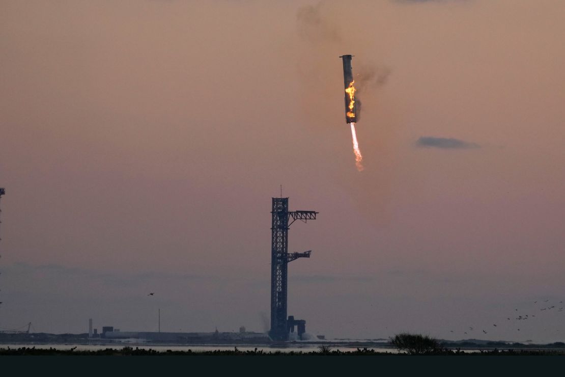 SpaceX's Super Heavy rocket booster returns to the launchpad to be captured by Mechazilla's "chopsticks" during a test flight on October 13.