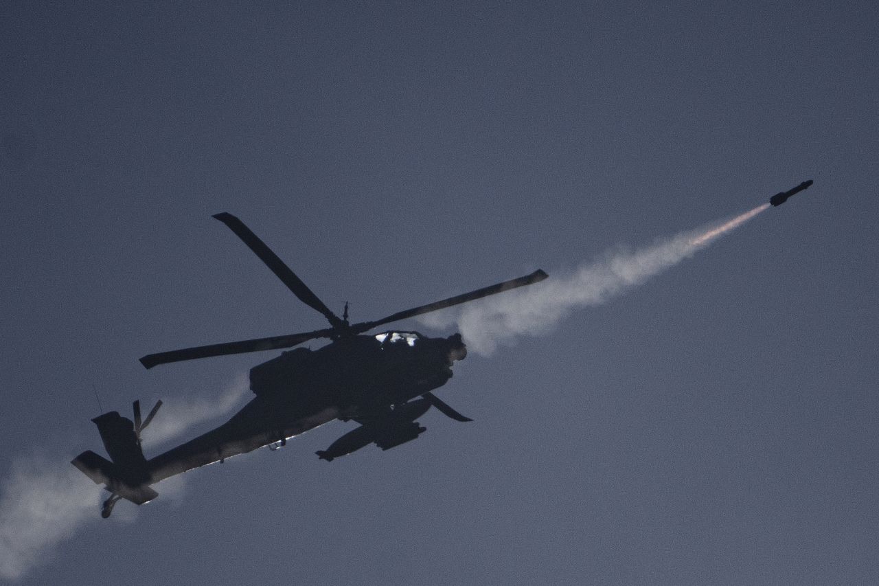 An Israeli Apache helicopter fires a missile towards southern Lebanon, as seen from northern Israel, on October 13.