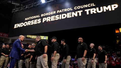 Republican presidential nominee Donald Trump greets members of the US Border Patrol as he speaks at a campaign rally in Prescott Valley, Arizona, on October 13, 2024.