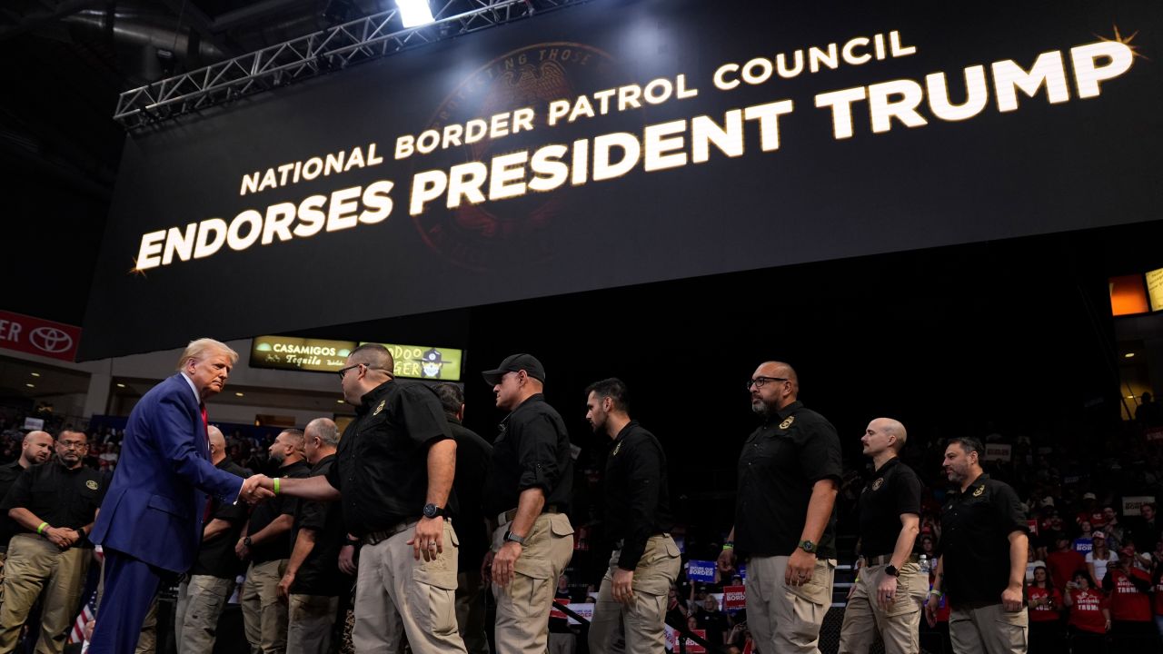 Republican presidential nominee Donald Trump greets members of the US Border Patrol as he speaks at a campaign rally in Prescott Valley, Arizona, on October 13, 2024.