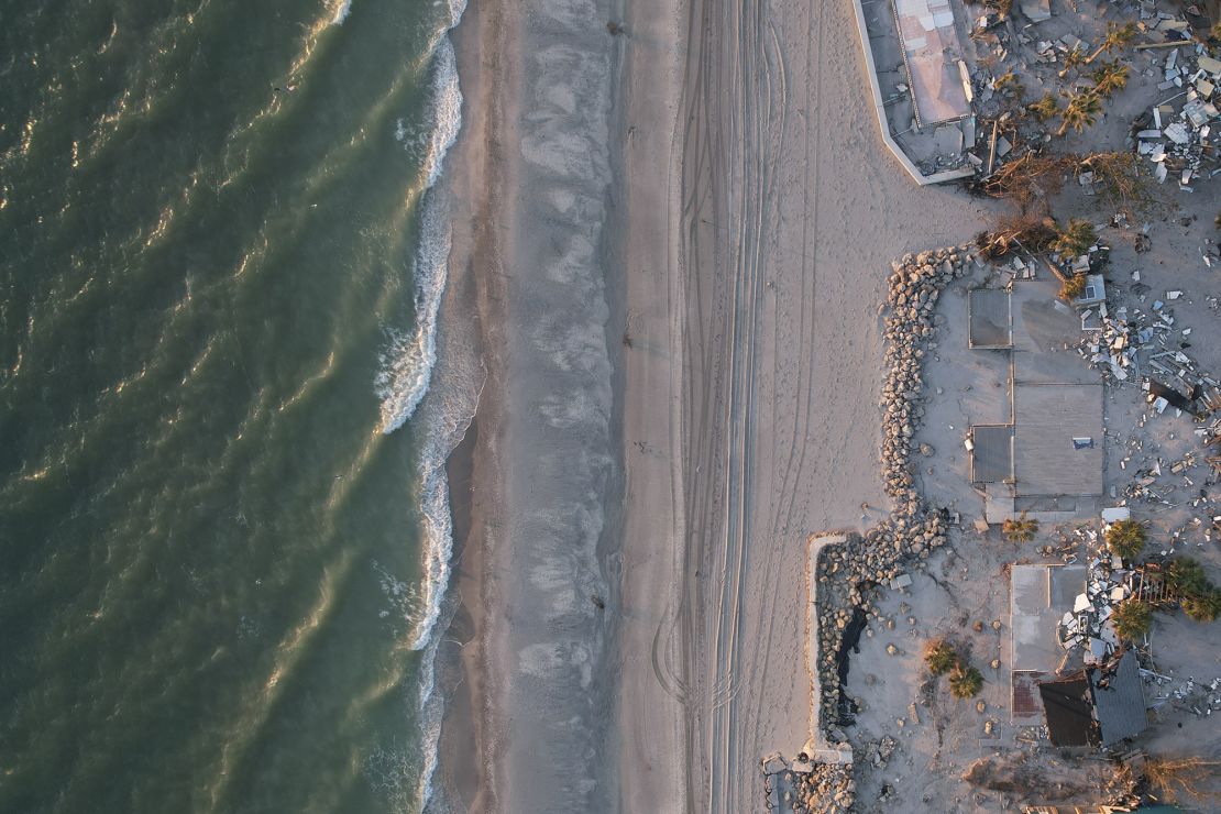 Waves roll in from the Gulf of Mexico toward lots where only empty foundations and debris remain after homes were swept away in Hurricane Milton, on Manasota Key in Englewood, Florida, Sunday, October 13, 2024.