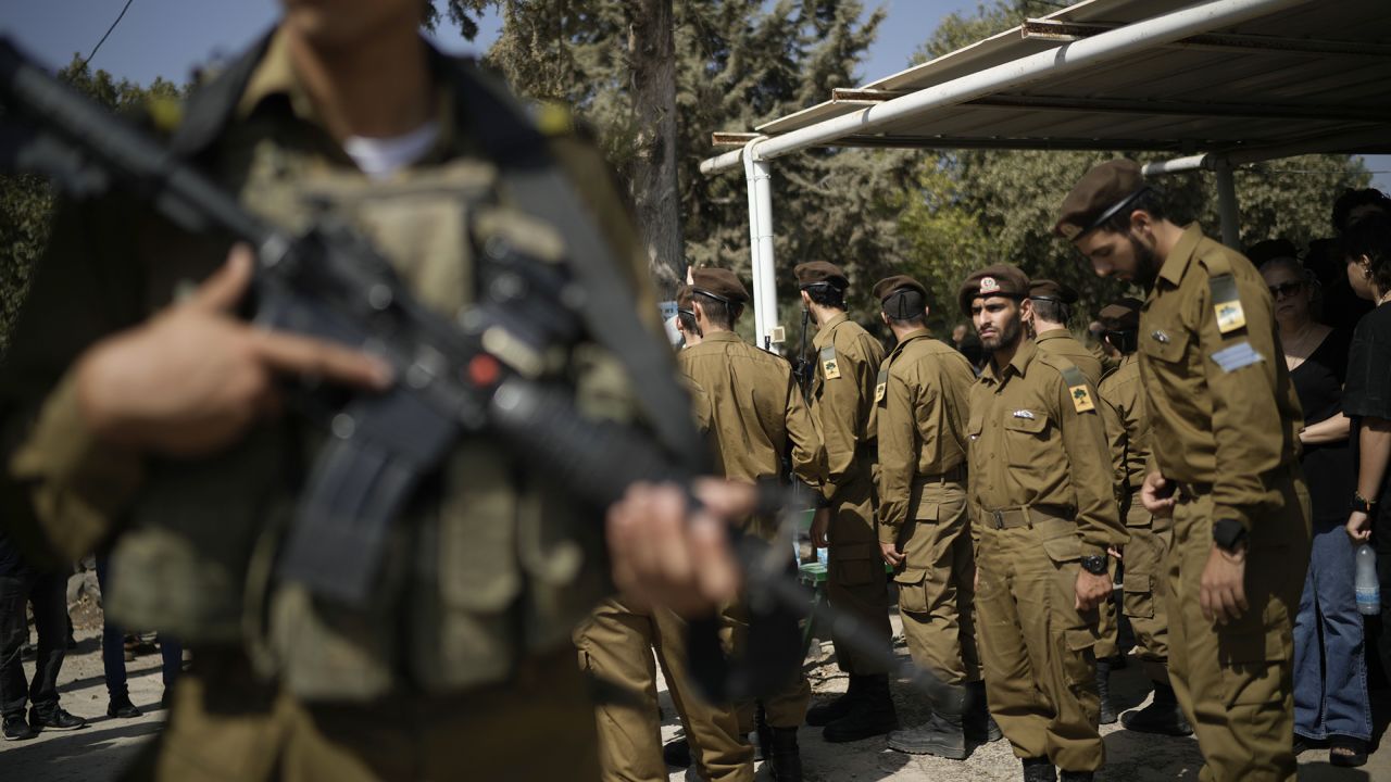 Israeli soldiers mourn Sgt. Yosef Hieb, killed Sunday by a Hezbollah drone attack that wounded dozens and killed four soldiers, while at his funeral in Tuba Zangariyye, Israel, Monday, Oct. 14, 2024. (AP Photo/Leo Correa)