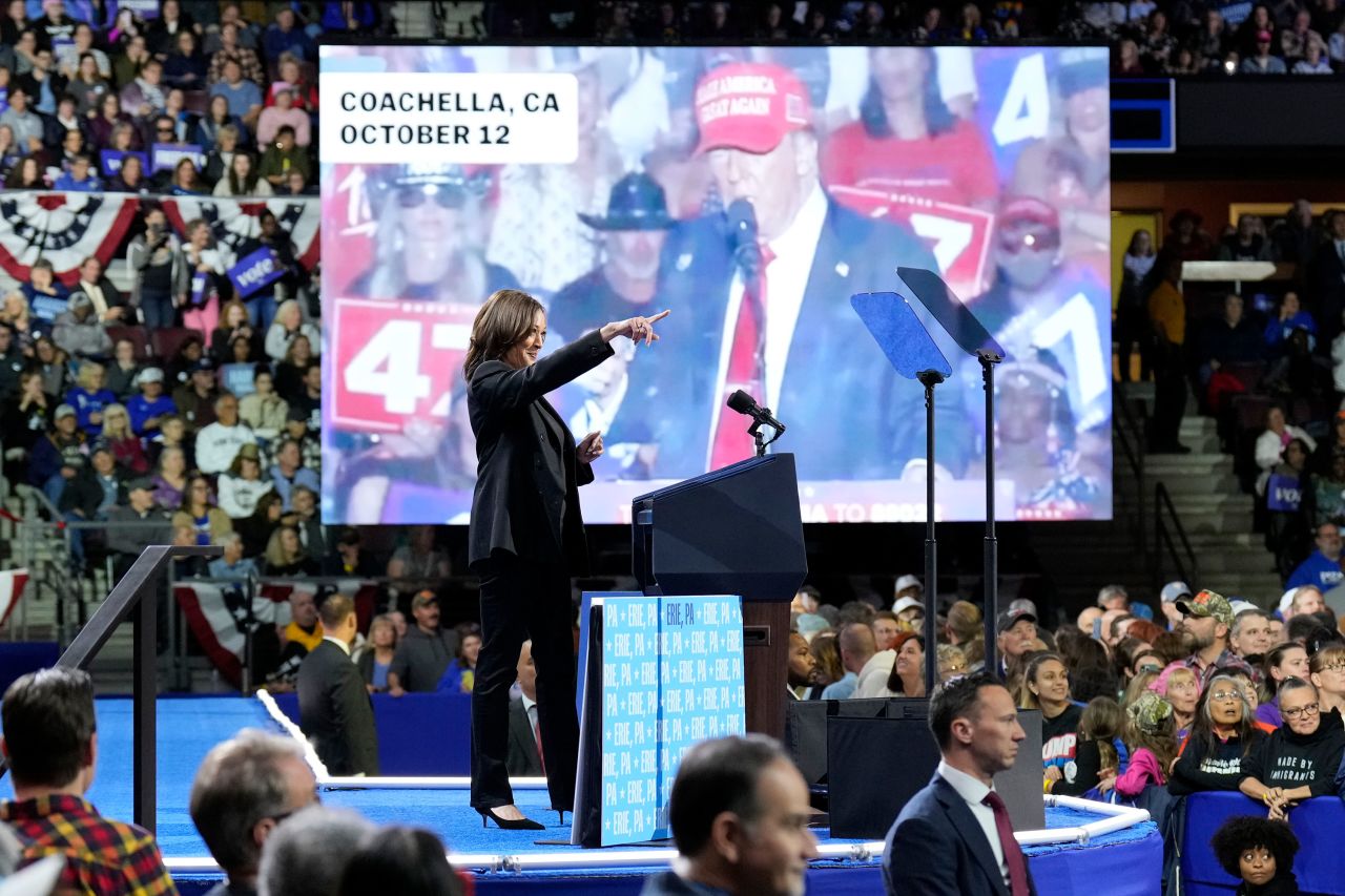 Vice President Kamala Harris gestures as a video of former President Donald Trump plays on screen during a campaign rally in Erie, Pennsylvania, on Monday.