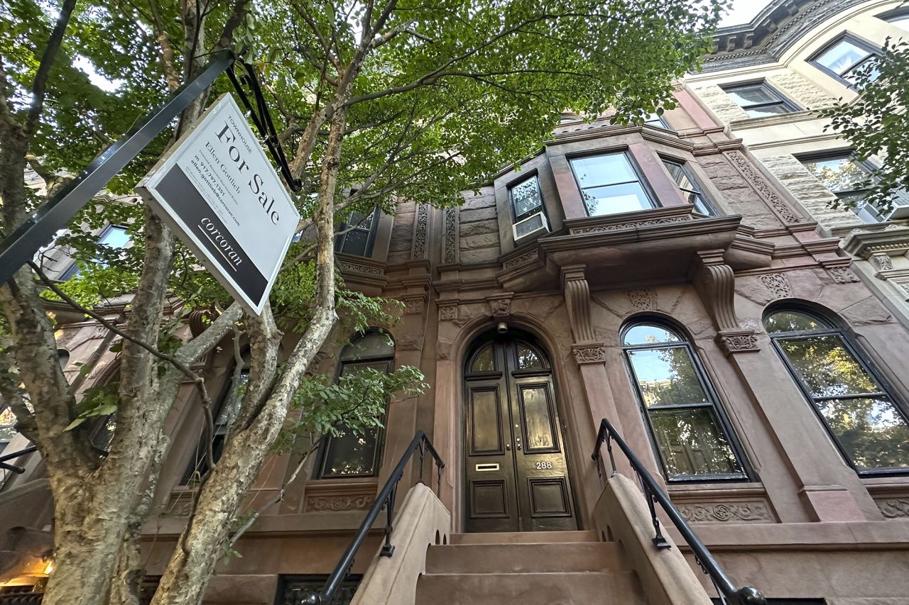 A for sale sign hangs in front of a townhouse in the Park Slope neighborhood in the borough of Brooklyn in New York on October 10.