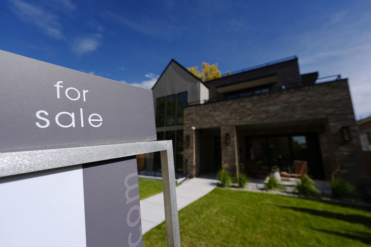 A sale sign stands outside a home in Denver on October 17.