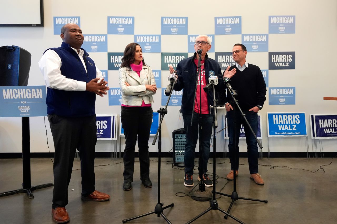 Chair of the Democratic National Committee Jaime Harrison, left, Michigan Gov. Gretchen Whitmer, Wisconsin Gov. Tony Evers and Pennsylvania Gov. Josh Shapiro talk to volunteers during a campaign event in Flint, Michigan, on October 17.