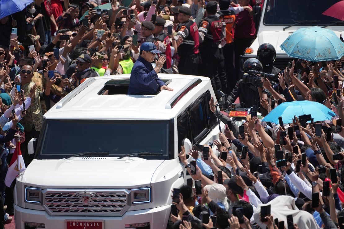 Newly-inaugurated Indonesian President Prabowo Subianto greets supporters after being sworn in as the country's eighth president in Jakarta on Oct. 20, 2024.