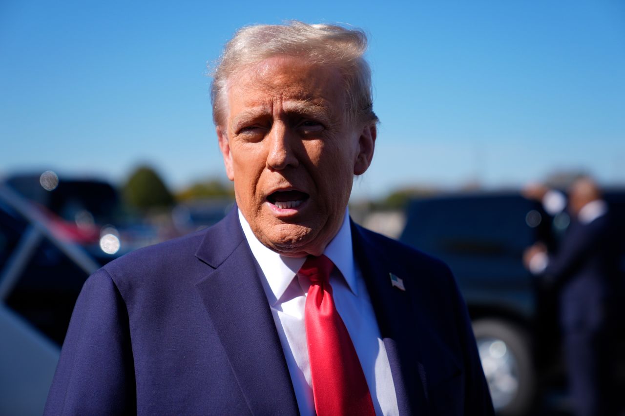 Former President Donald Trump speaks with reporters at Philadelphia International Airport on October 20.