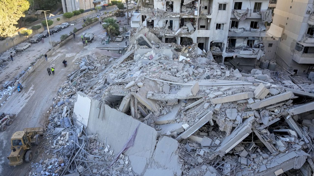 Rescue workers use a bulldozer to remove rubble at the site of an Israeli airstrike on Sunday night that hit several branches of the Hezbollah run Al-Qard Al-Hassan Association in Beirut, Lebanon, on October 21.