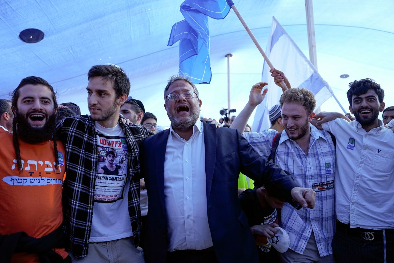 National Security Minister Itamar Ben Gvir, center, dances during a conference calling for Jewish resettlement of the Gaza Strip near the Israeli-Gaza border in southern Israel on Monday.