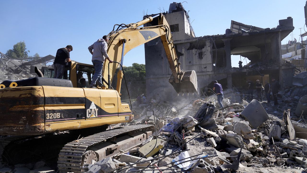 A bulldozer clears the rubble of destroyed buildings following Israeli airstrikes in a densely-populated neighbourhood facing the Rafik Hariri State Hospital in Beirut, Lebanon, on October 22.