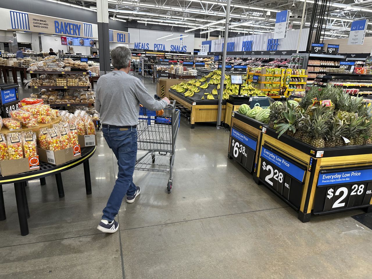 Shopper pushes a basket into the produce section of a Walmart store on October 22 in Englewood, Colorado.