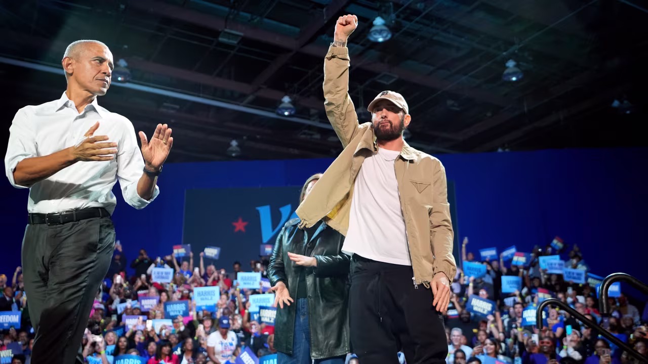 Rapper Eminem, center, greets the crowd on stage with former President Barack Obama, left, at a campaign rally supporting Democratic presidential nominee Vice President Kamala Harris, in Detroit on October 22.