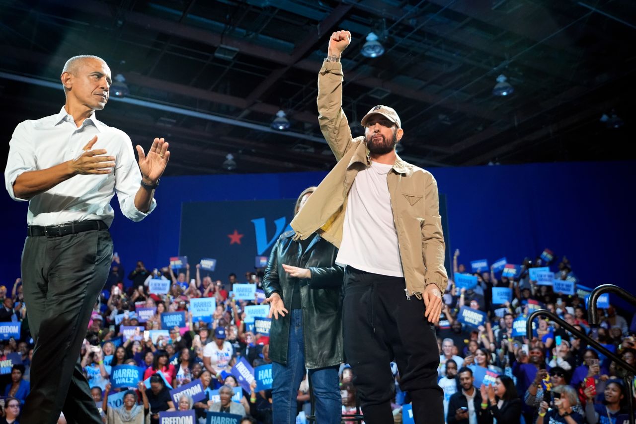 Rapper Eminem, center, greets the crowd on stage with former President Barack Obama, left, at a campaign rally supporting Democratic presidential nominee Vice President Kamala Harris, in Detroit on October 22.