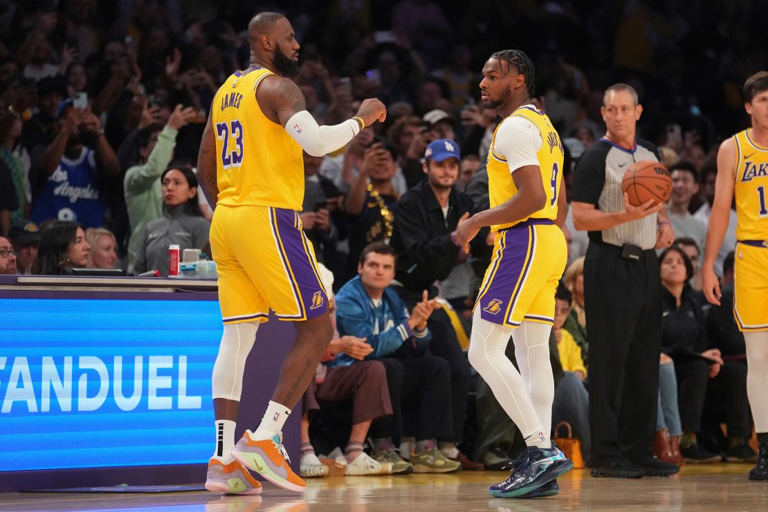 Los Angeles Lakers forward LeBron James and guard Bronny James make history as first father and son to play together in an NBA game.