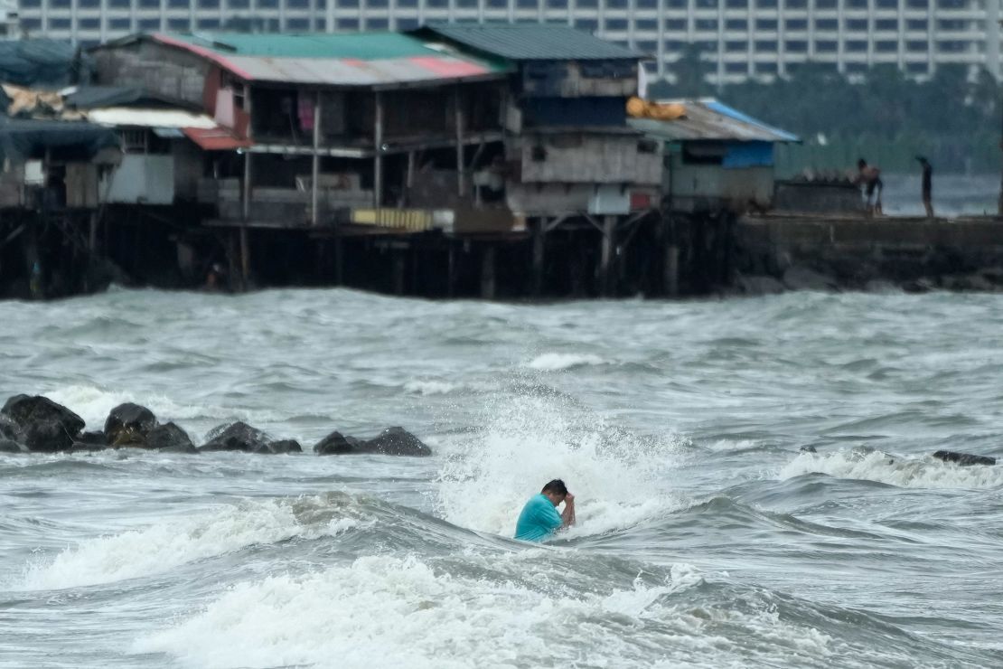 A resident swims despite the strong waves caused by Tropical Storm Trami in Manila, Philippines, on October 23, 2024.