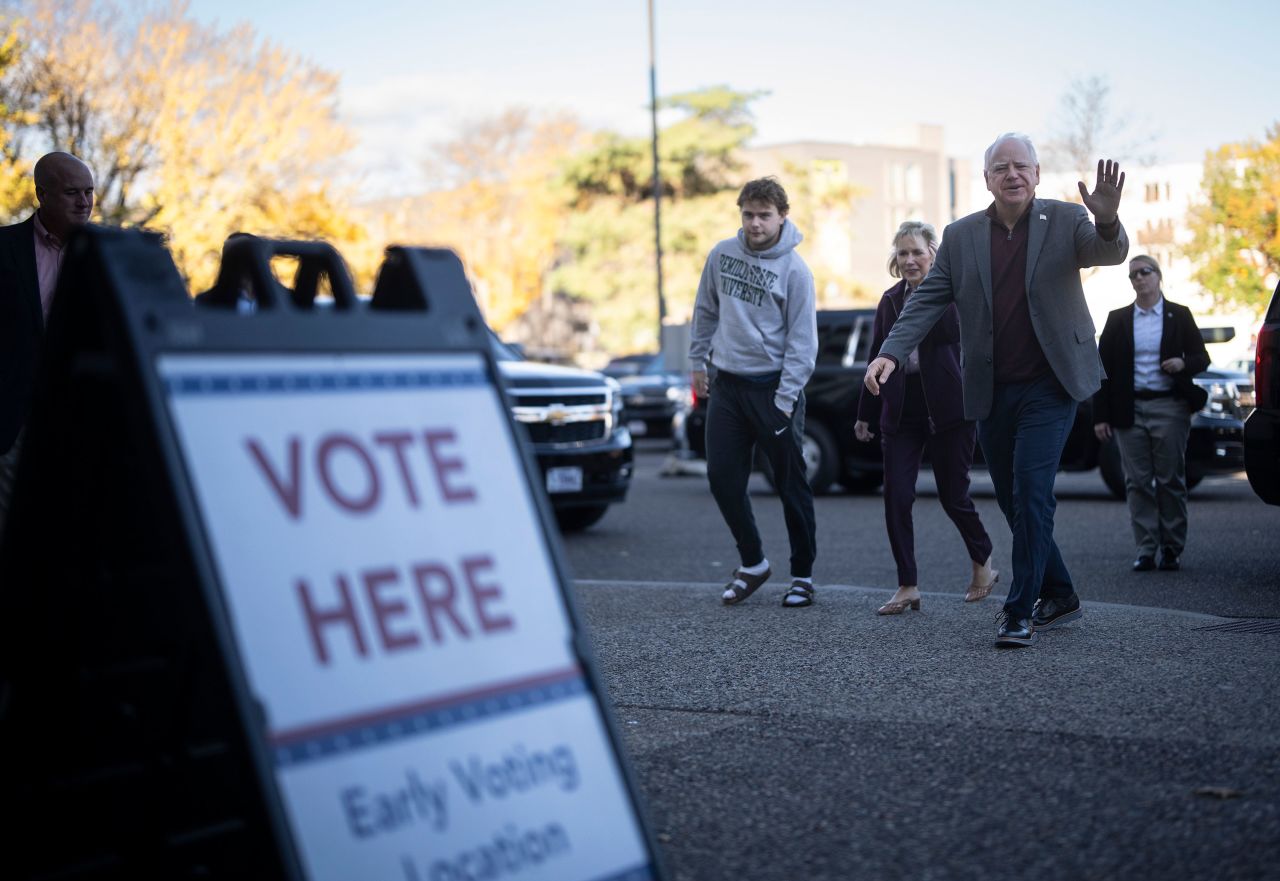 Minnesota Gov. Tim Walz enters the Ramsey County Elections office with his wife, Gwen, and son, Gus, to early vote in St. Paul, Minnesota, on Wednesday, October 23.