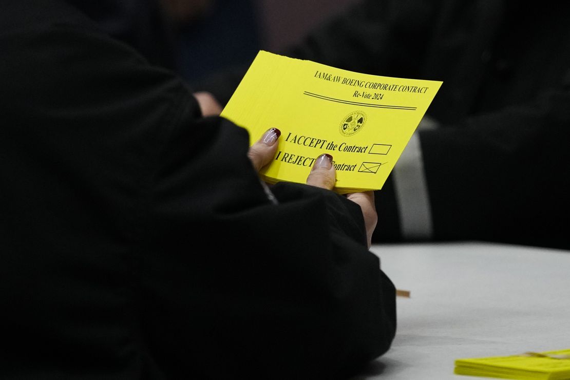 A volunteer holds a vote to reject a new contract offer from Boeing during vote counting Wednesday.