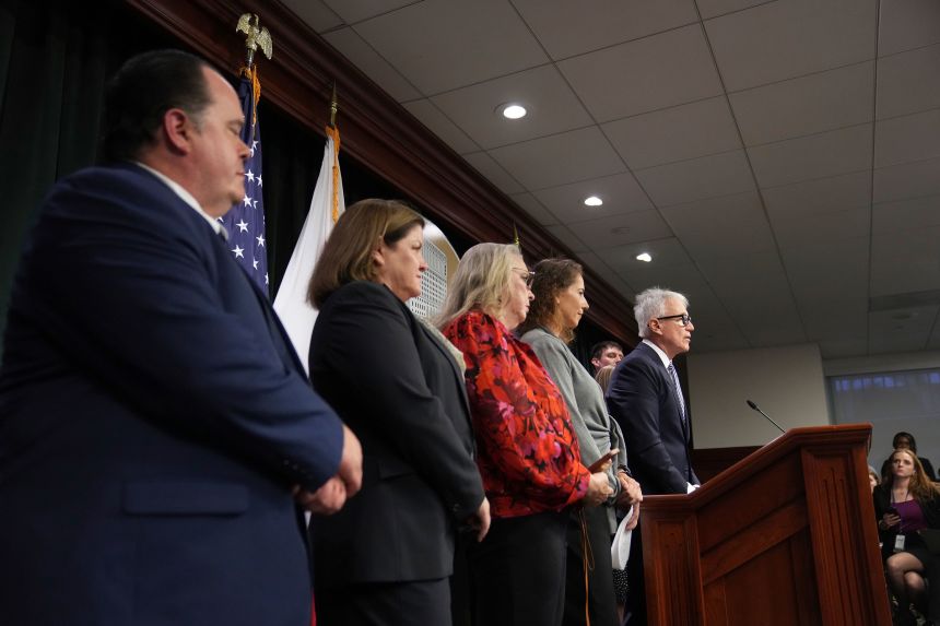 Los Angeles County District Attorney George Gascon, flanked by Menendez family members, speaks during a news conference on October 24, 2024.