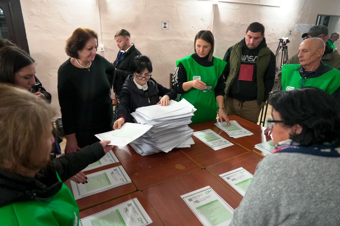 Members of an election commission count ballots at a polling station after the parliamentary election in Tbilisi, Georgia, on Oct. 26, 2024.