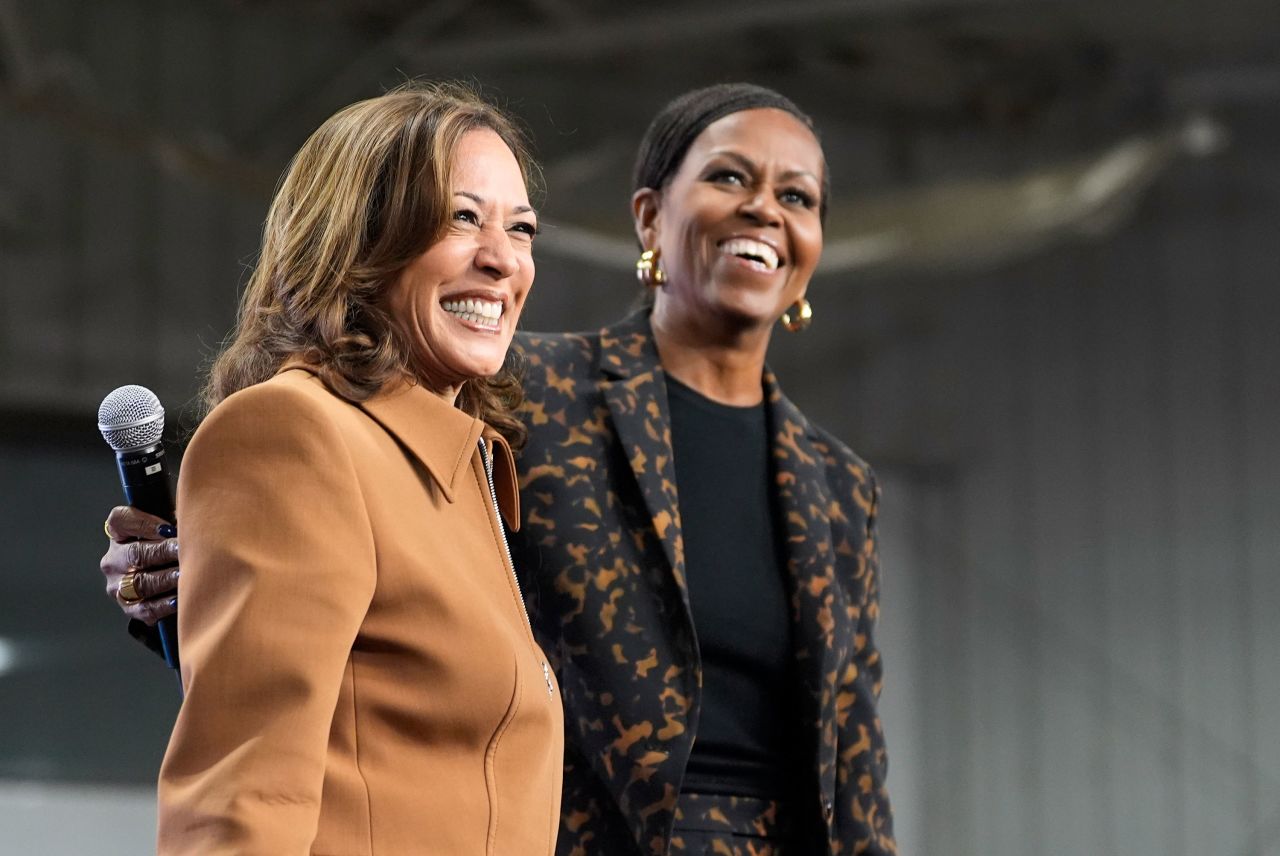 Vice President Kamala Harris and former first lady Michelle Obama address the crowd in the overflow space of a campaign rally in Kalamazoo, Michigan, on Saturday.