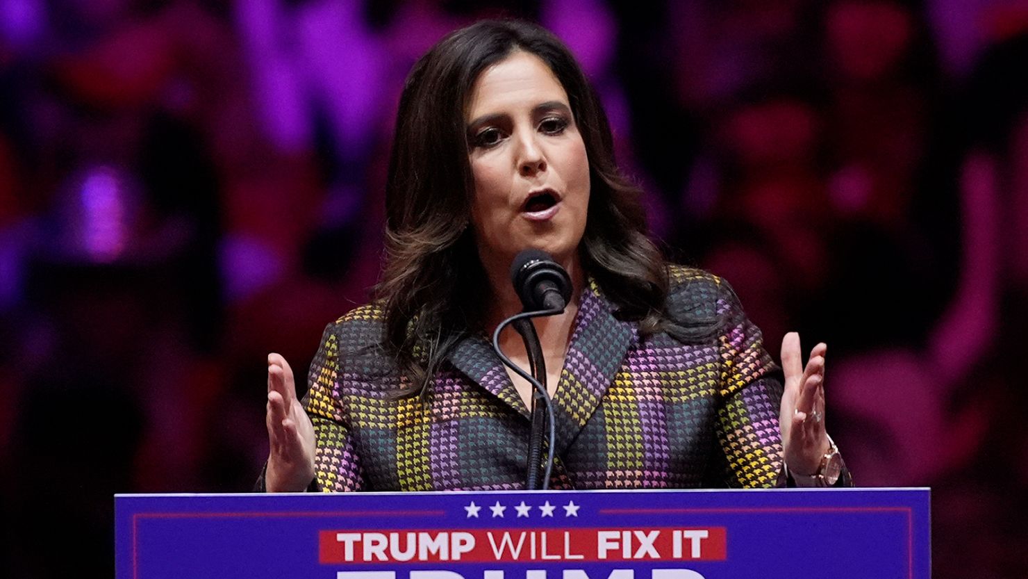 a close up of a woman giving a speech at a podium