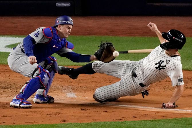 The Yankees' Giancarlo Stanton is tagged out at home by Dodgers catcher Will Smith during Game 3 of the World Series on Monday. <a href="index.php?page=&url=https%3A%2F%2Fwww.cnn.com%2F2024%2F10%2F28%2Fsport%2Fyankees-dodgers-world-series-game-3-spt-intl%2Findex.html">The Dodgers defeated the Yankees 4-2</a> to take a 3-0 lead in the best-of-seven series.