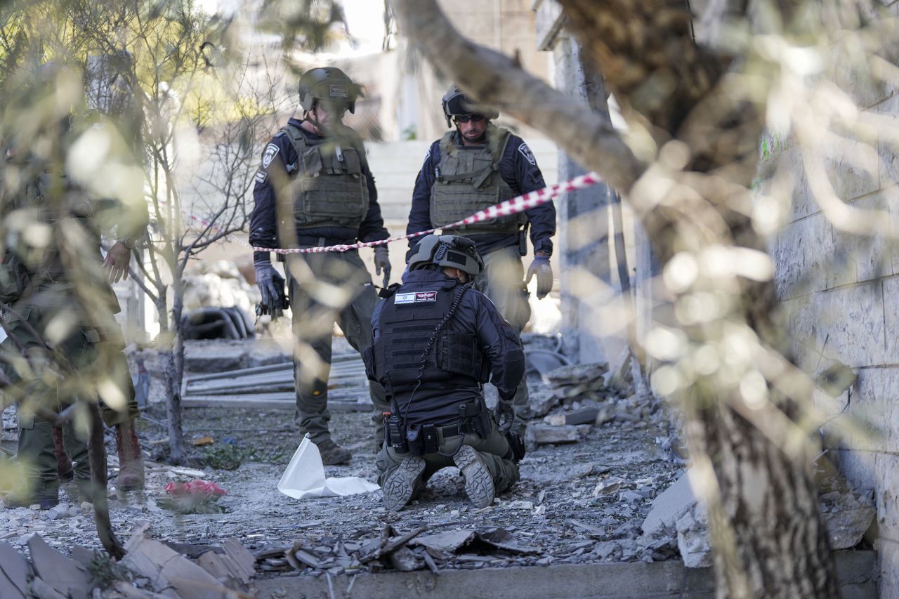 Members of the Israeli police bomb squad work at the site where one person was killed after a projectile launched from Lebanon slammed into Maalot-Tarshiha, Israel, on October 29.