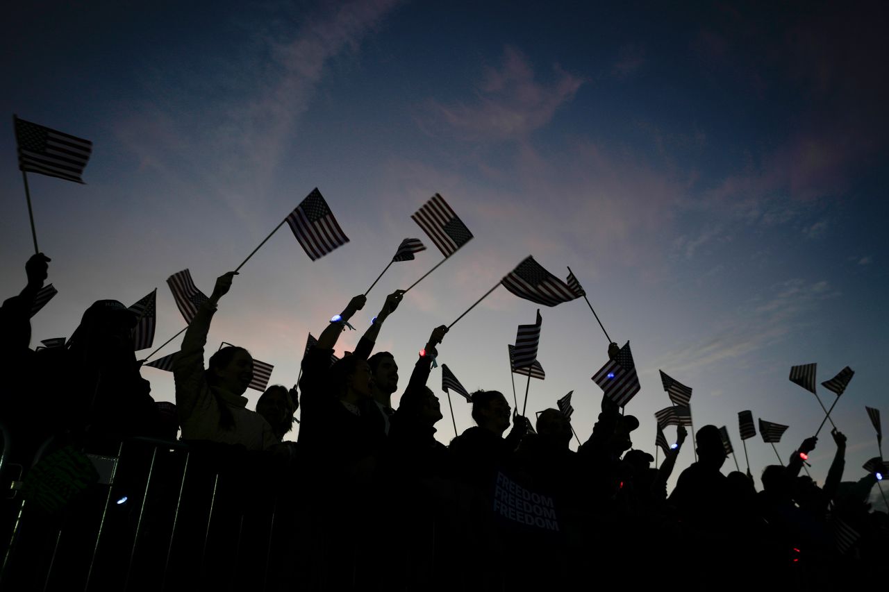 Supporters cheer as Kamala Harris speaks.