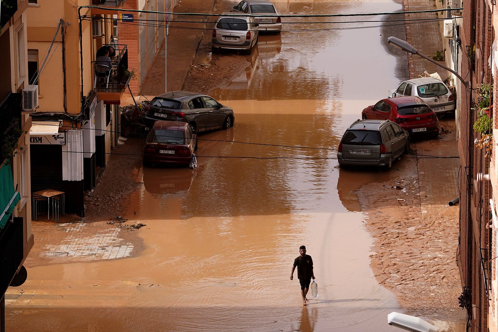 A man walks through a flooded street in Valencia on Wednesday.