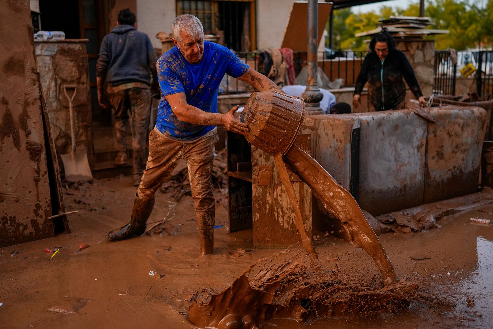 A man dumps flood water out of his house in Utiel on Wednesday.