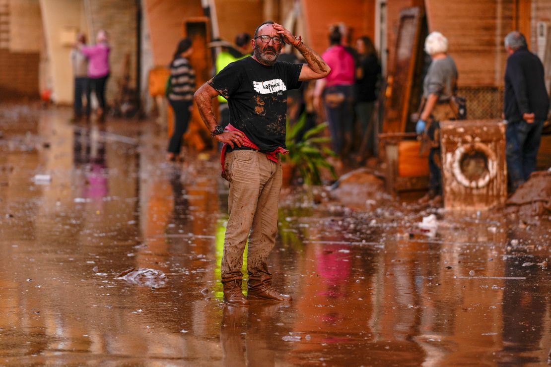 A man reacts in front of flood-affected houses in Utiel, Valencia, on October 30, 2024.