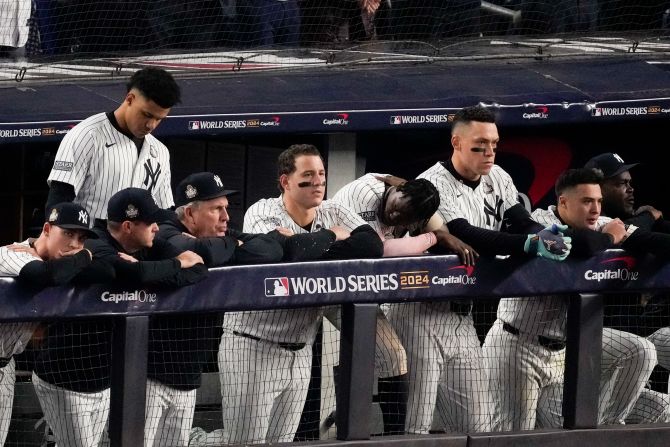 Dejected Yankees watch from the dugout after the final pitch Wednesday.