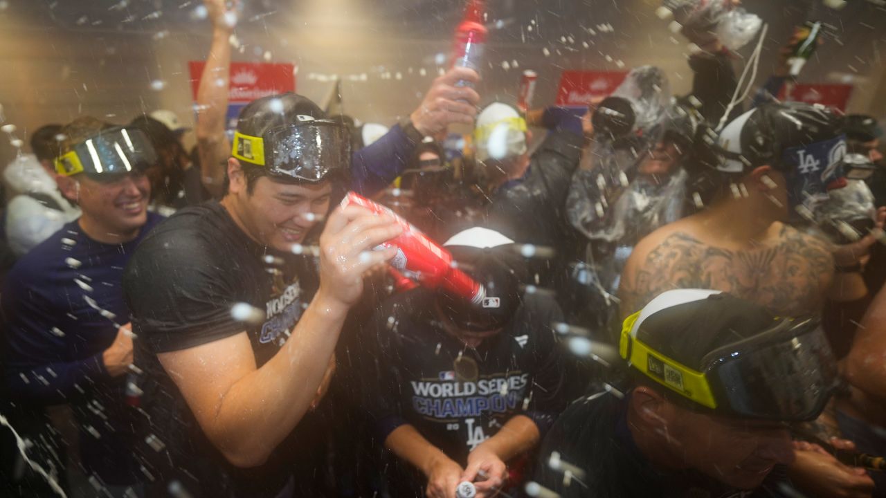 Los Angeles Dodgers' Shohei Ohtani celebrates in the locker room after their win against the New York Yankees in Game 5 to win the baseball World Series, Thursday, Oct. 31, 2024, in New York. (AP Photo/Ashley Landis)