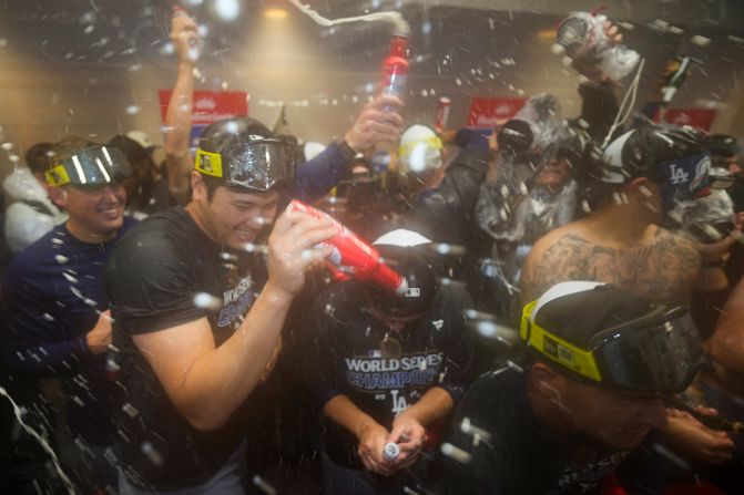 The Dodgers' Shohei Ohtani, front left, celebrates with teammates in the locker room after Wednesday's win.